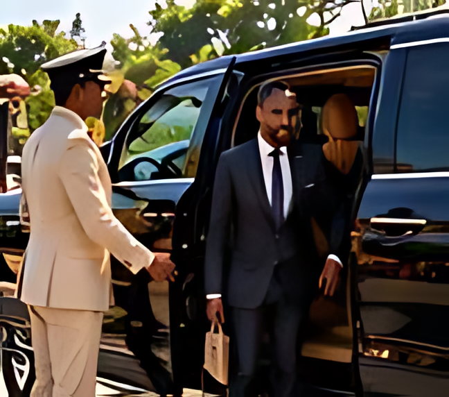 A chauffeur in uniform holding the car door open for a guest