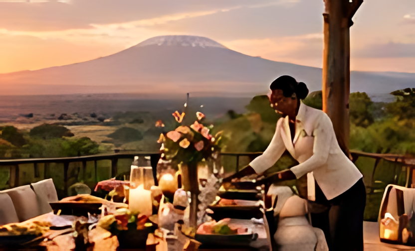 A terrace dining table set beneath a view of Kilimanjaro